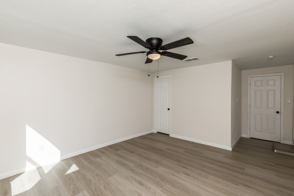 5260 Landry Lane Beaumont, TX 77708 - Photo 15 of 25 a view of a room with wooden floor and a ceiling fan