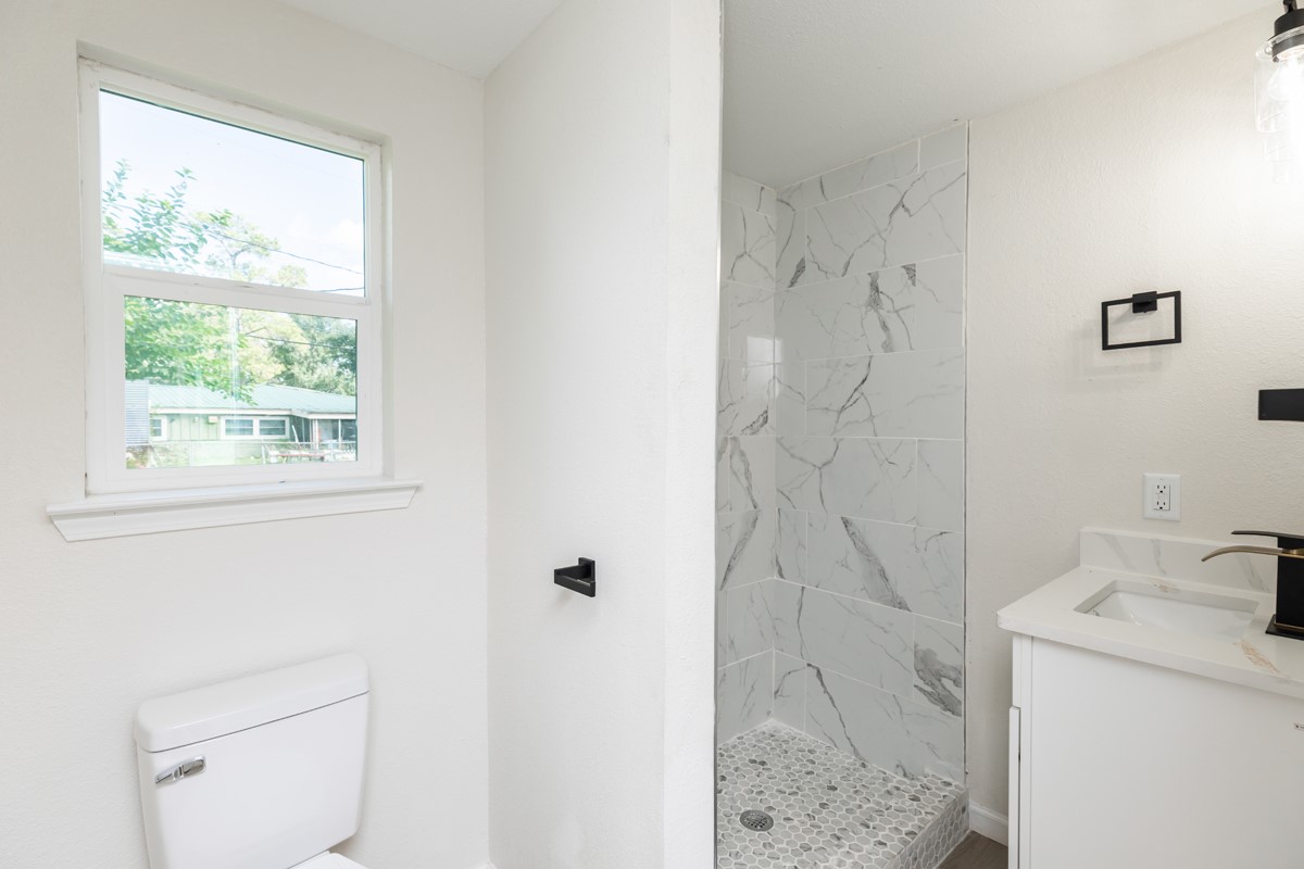 5260 Landry Lane Beaumont, TX 77708 - Photo 16 of 25 a bathroom with a sink a toilet and shower