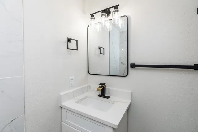 a bathroom with a sink and mirror