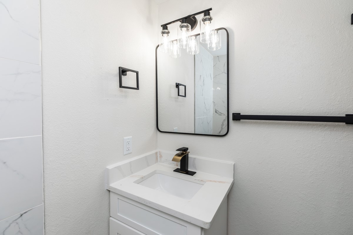 5260 Landry Lane Beaumont, TX 77708 - Photo 17 of 25 a bathroom with a sink and mirror