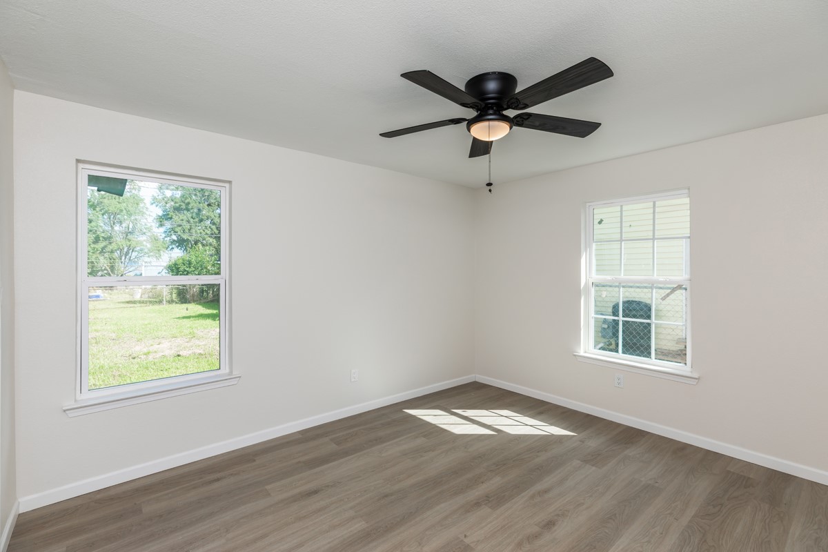 5260 Landry Lane Beaumont, TX 77708 - Photo 21 of 25 a view of empty room with wooden floor and fan