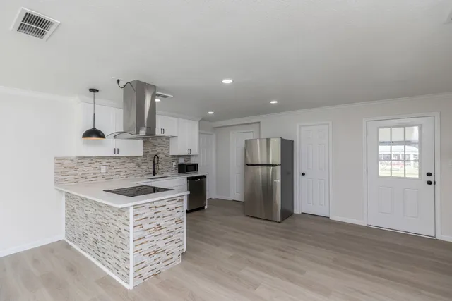 a kitchen with stainless steel appliances granite countertop a stove and a refrigerator