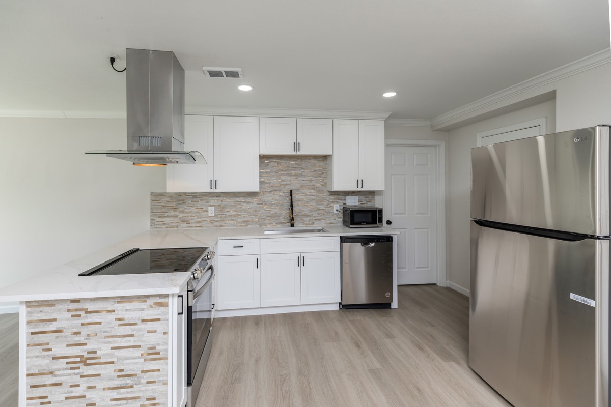 5260 Landry Lane Beaumont, TX 77708 - Photo 8 of 25 a kitchen with a refrigerator and a sink