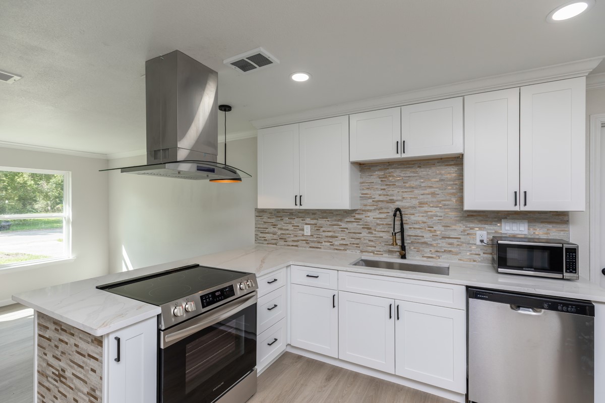 5260 Landry Lane Beaumont, TX 77708 - Photo 9 of 25 a kitchen with granite countertop a stove sink and cabinets