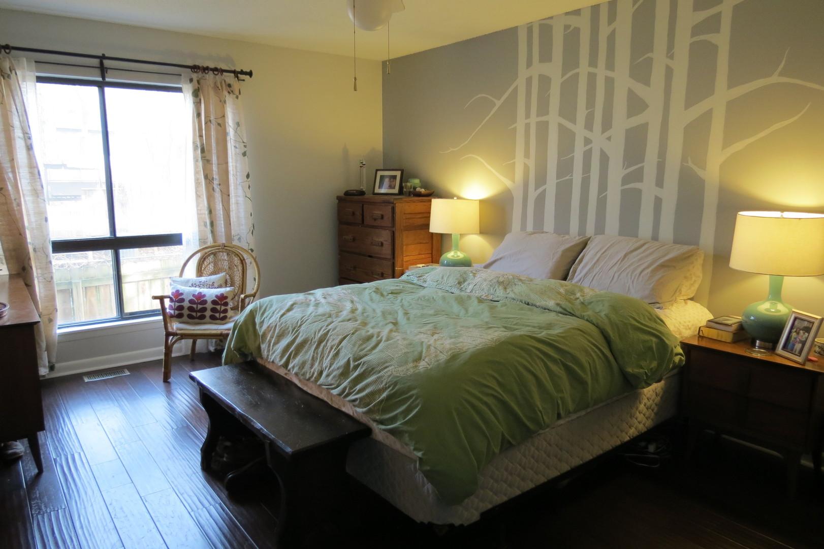 805 Castalia Drive Cary, NC 27513 - Photo 7 of 9 a bedroom with a bed and wooden floor