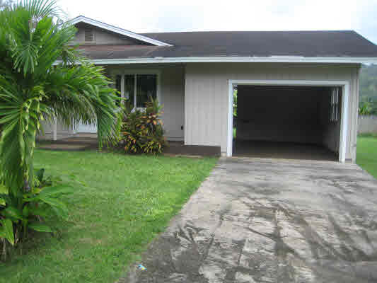 4095 Koloa Road Koloa, HI 96756 - Photo 1 of 1 a view of yellow house with a yard and a garage