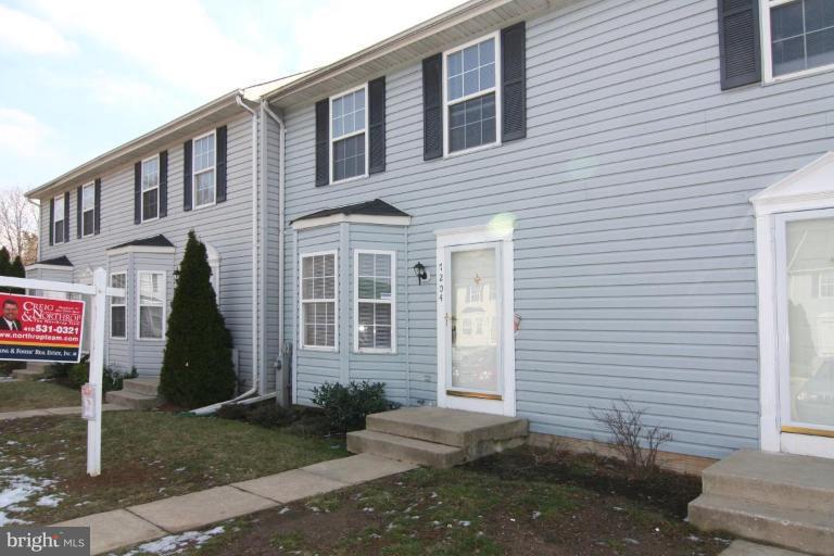 7204 Rutherford Green Circle Windsor Mill, MD 21244 - Photo 1 of 13 a front view of a house with a yard