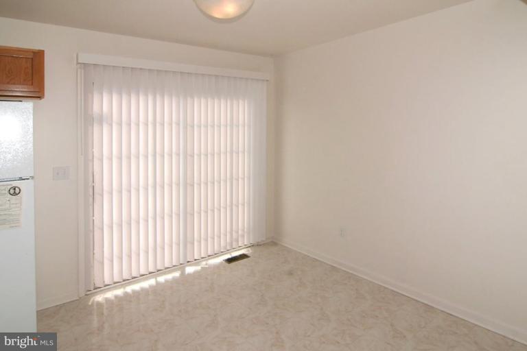 7204 Rutherford Green Circle Windsor Mill, MD 21244 - Photo 6 of 13 an empty room with windows