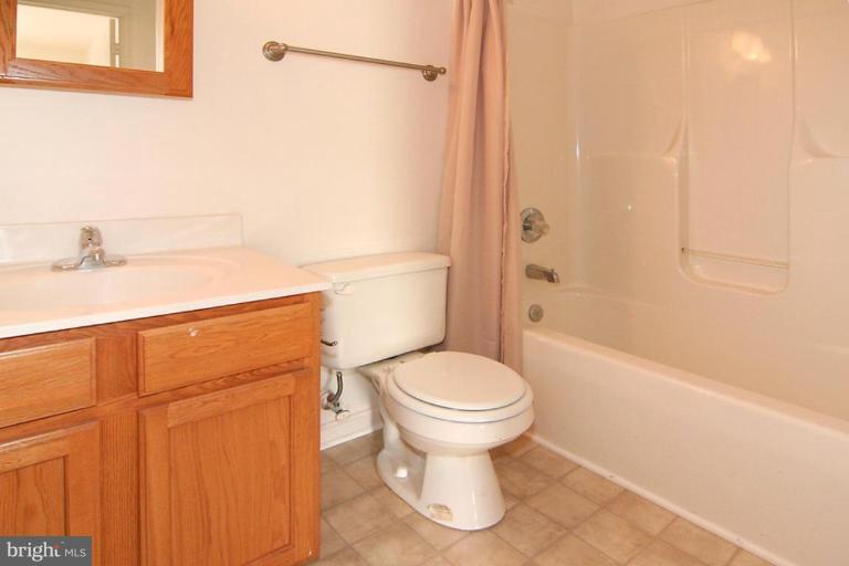 7204 Rutherford Green Circle Windsor Mill, MD 21244 - Photo 9 of 13 a bathroom with a sink a toilet and shower