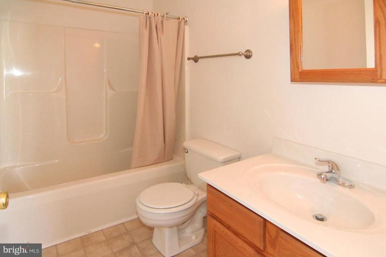 7204 Rutherford Green Circle Windsor Mill, MD 21244 - Photo 10 of 13 a bathroom with a sink a toilet and shower