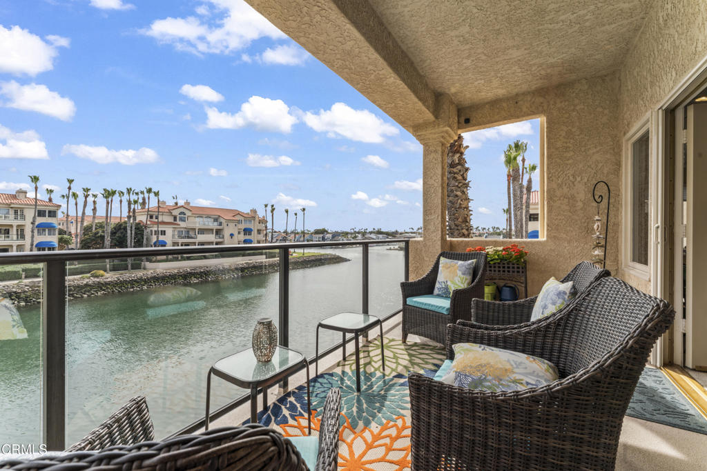 a balcony with furniture and view of lake