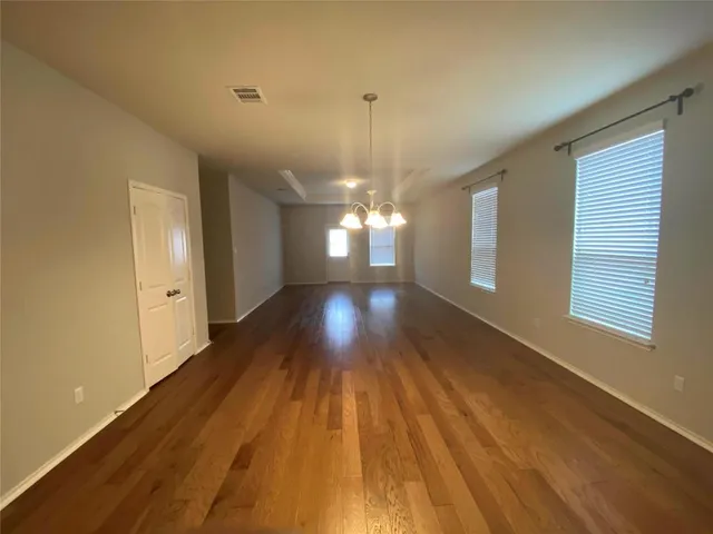 a view of a room with wooden floor