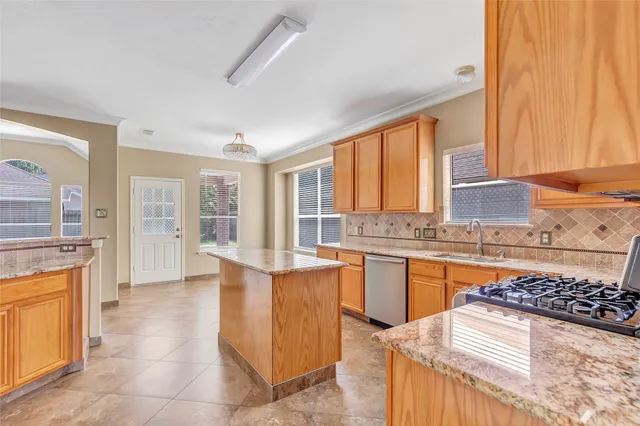 a kitchen with stainless steel appliances granite countertop a stove and a sink