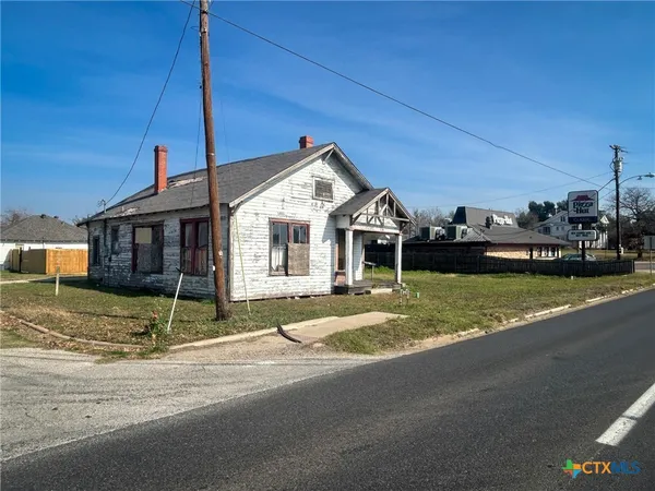 a view of a house next to a yard