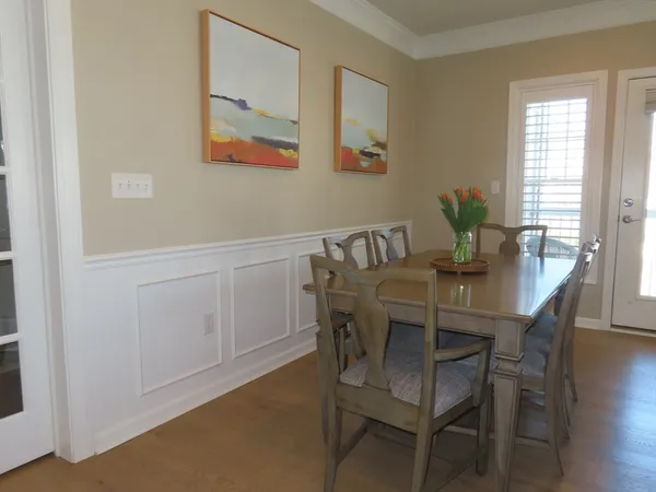 a view of a dining room with furniture and window