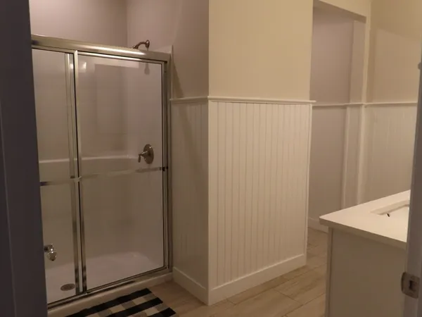 a bathroom with a glass shower door