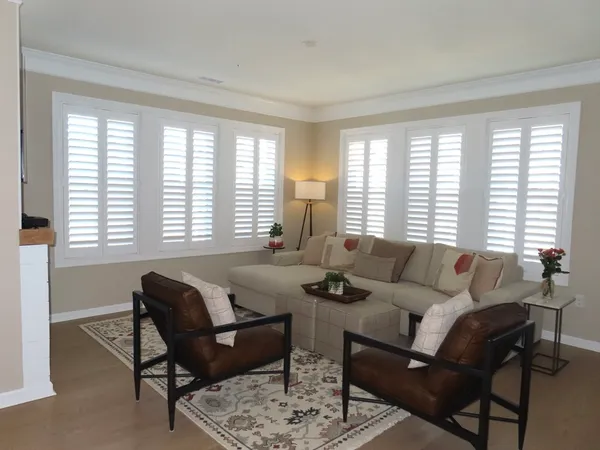 a living room with furniture and large windows