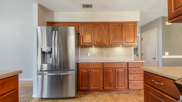 a kitchen with stainless steel appliances granite countertop a refrigerator and a stove