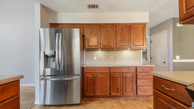 a kitchen with stainless steel appliances granite countertop a refrigerator and a stove