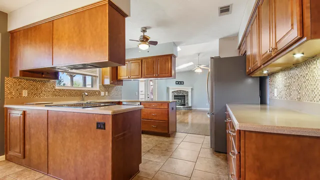 a kitchen with stainless steel appliances granite countertop a stove a sink and a refrigerator