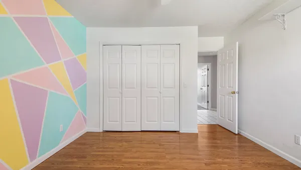 a view of an entryway with wooden floor
