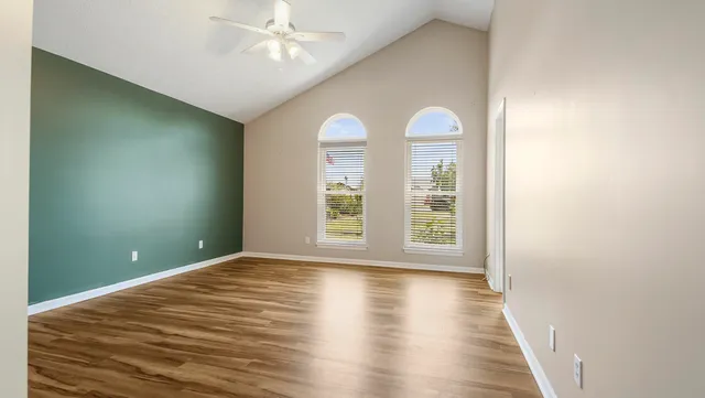 wooden floor in an empty room with a window