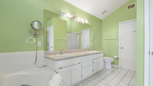 a spacious bathroom with a granite countertop sink mirror and toilet