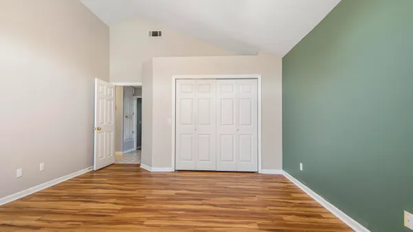 a view of a room with wooden floor