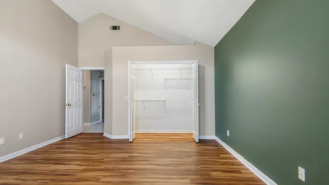 a view of a room with wooden floor