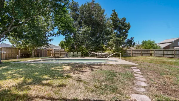 a view of a yard with table and chairs