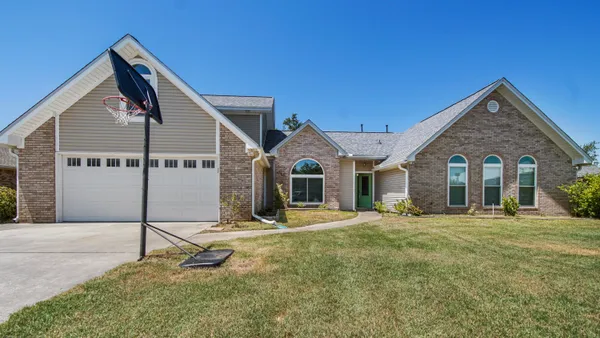 a front view of a house with a yard