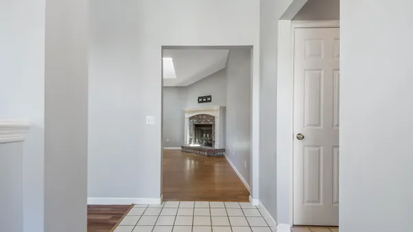 a view of a hallway to a livingroom with a fireplace