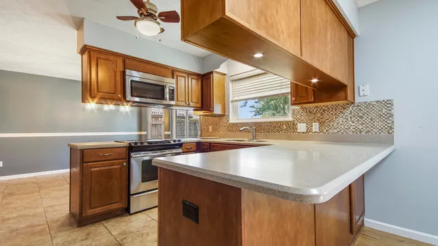 a kitchen with stainless steel appliances granite countertop a sink and a stove