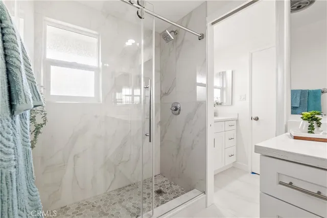 a bathroom with a shower and a sink