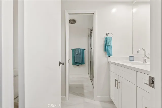 a bathroom with a shower sink and mirror