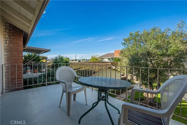 a balcony with table and chairs