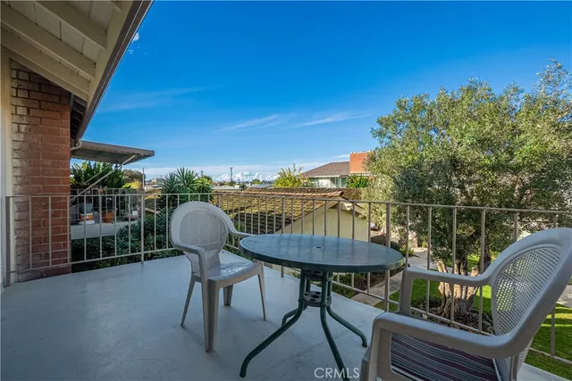 a balcony with table and chairs