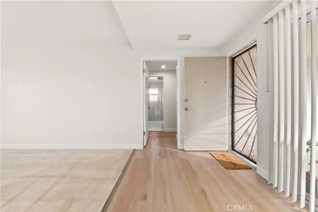 a view of hallway with wooden floor and stairs