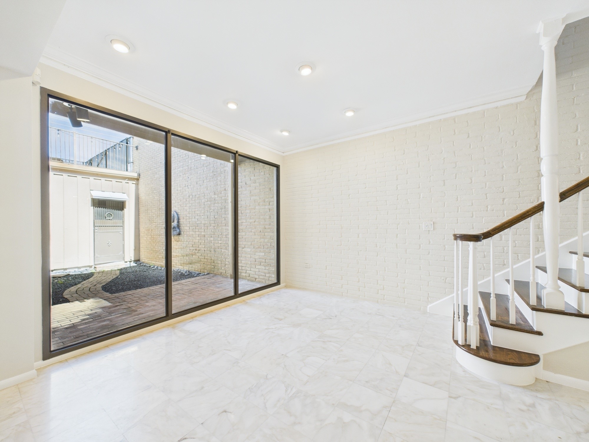 7608 Del Monte Drive Houston, TX 77063 - Photo 10 of 46 Bottom of the stairs is a perfect seating area for morning coffee and view of the atrium
