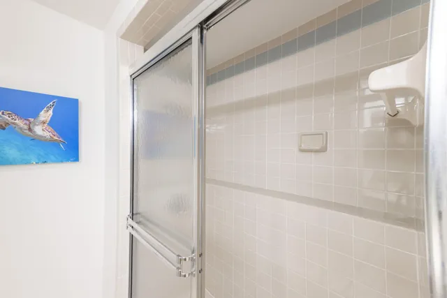 a bathroom with a glass shower door