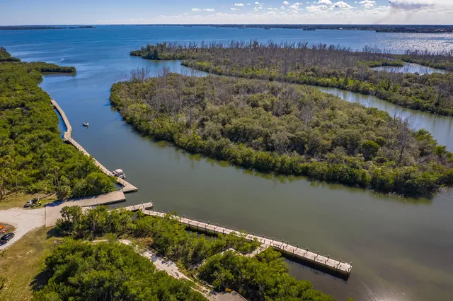 an aerial view of a house with a lake