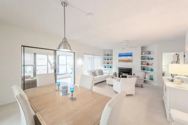 a living room with furniture a flat screen tv and a table