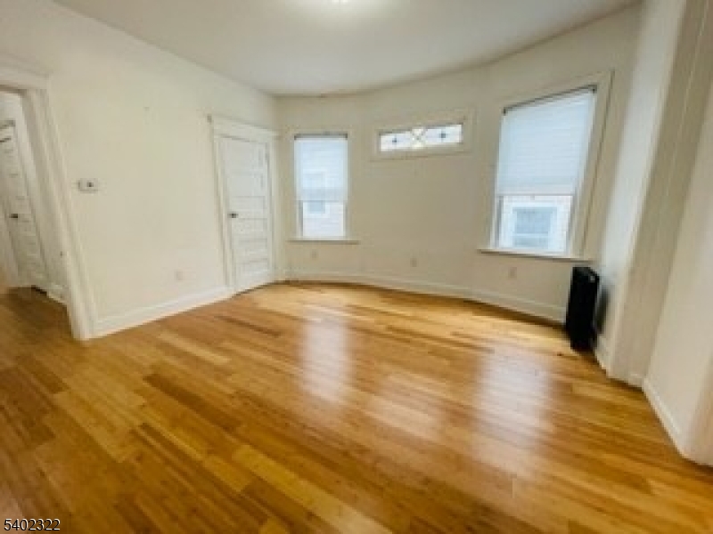 169 Hillside Avenue, Unit 2 Glen Ridge, NJ 07028 - Photo 4 of 10 a view of empty room with wooden floor and fan