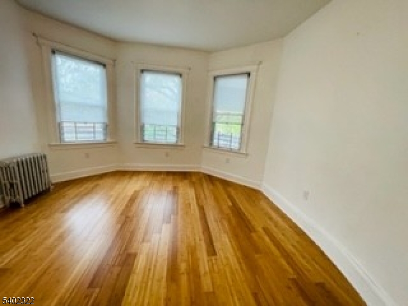 169 Hillside Avenue, Unit 2 Glen Ridge, NJ 07028 - Photo 6 of 10 a view of a room with wooden floor and window