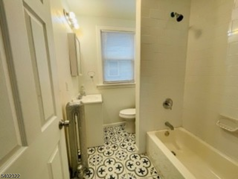 169 Hillside Avenue, Unit 2 Glen Ridge, NJ 07028 - Photo 9 of 10 a bathroom with a sink a toilet and shower