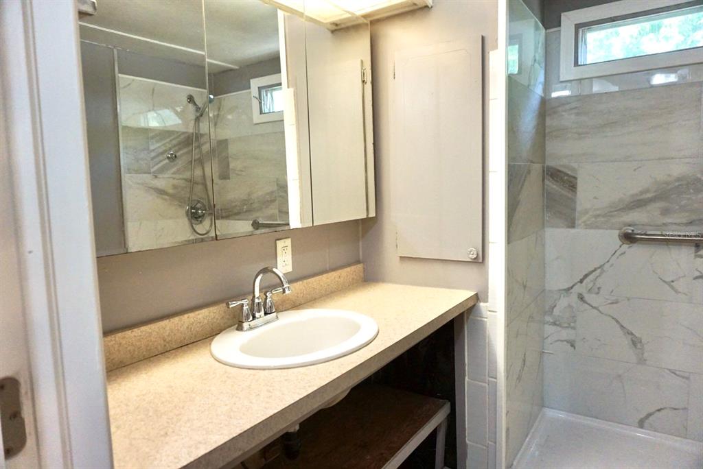 980 7th Street Northwest, Unit 71 Largo, FL 33770 - Photo 11 of 23 a bathroom with a sink and a mirror