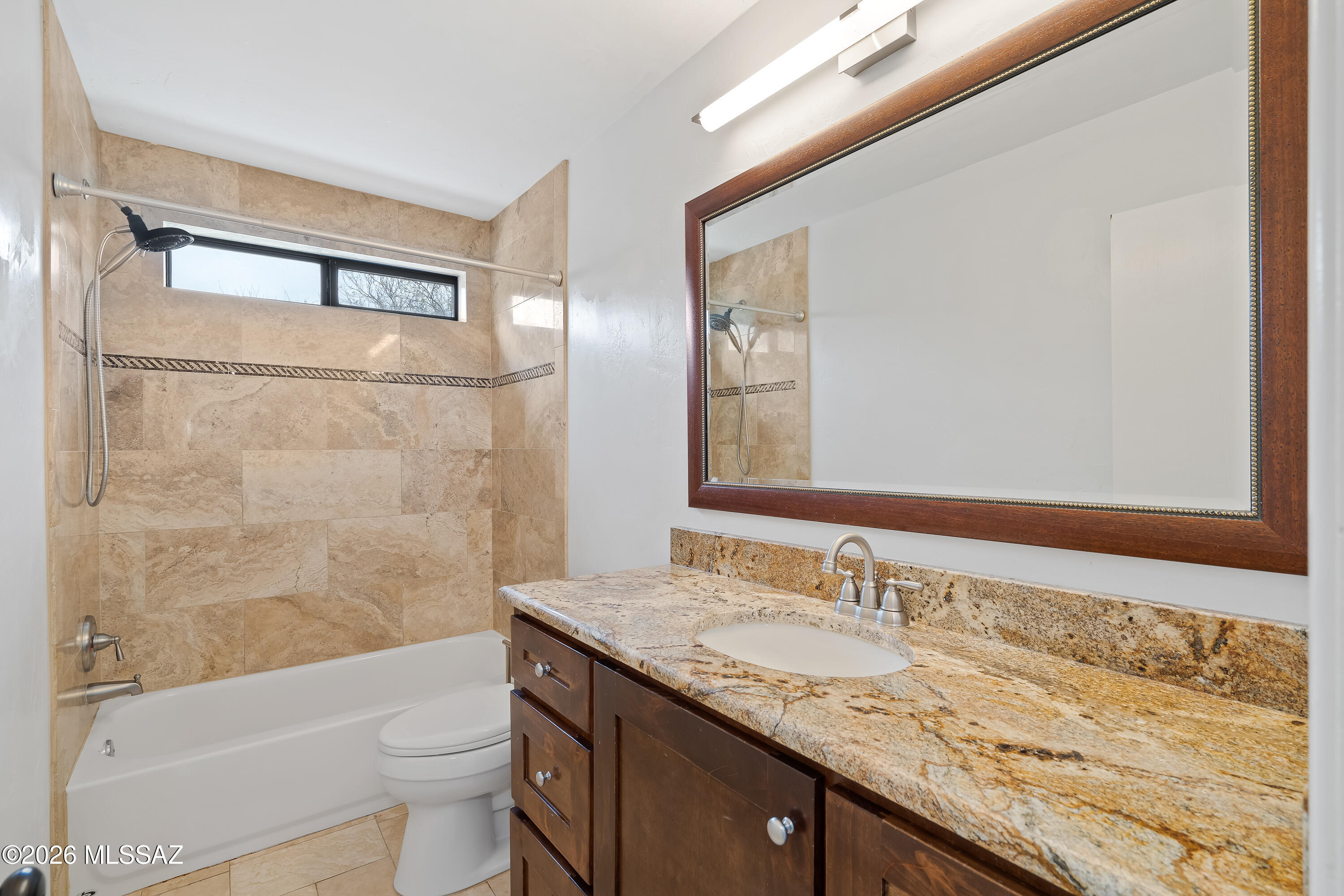 9420 East Ravine Trail Tucson, AZ 85749 - Photo 19 of 39 a bathroom with a granite countertop sink toilet and shower