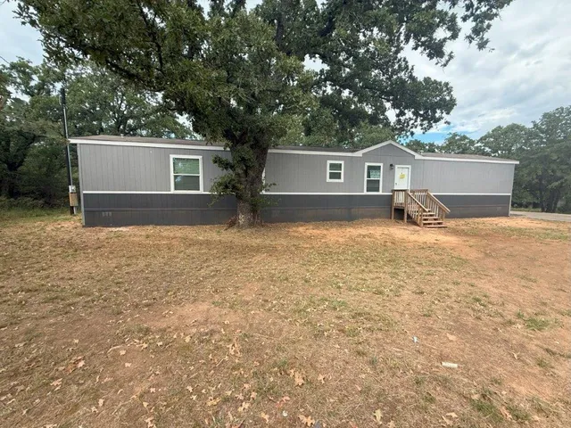 a house with trees in the background