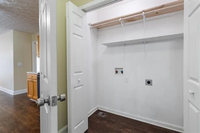 a view of a room with wooden floor