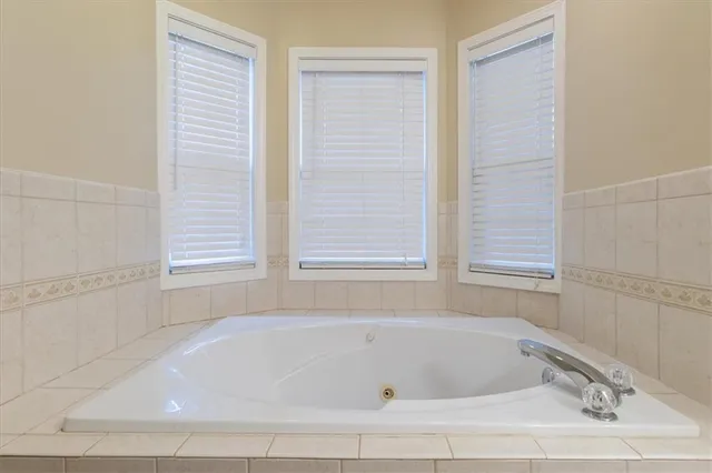 a white bath tub sitting next to a window